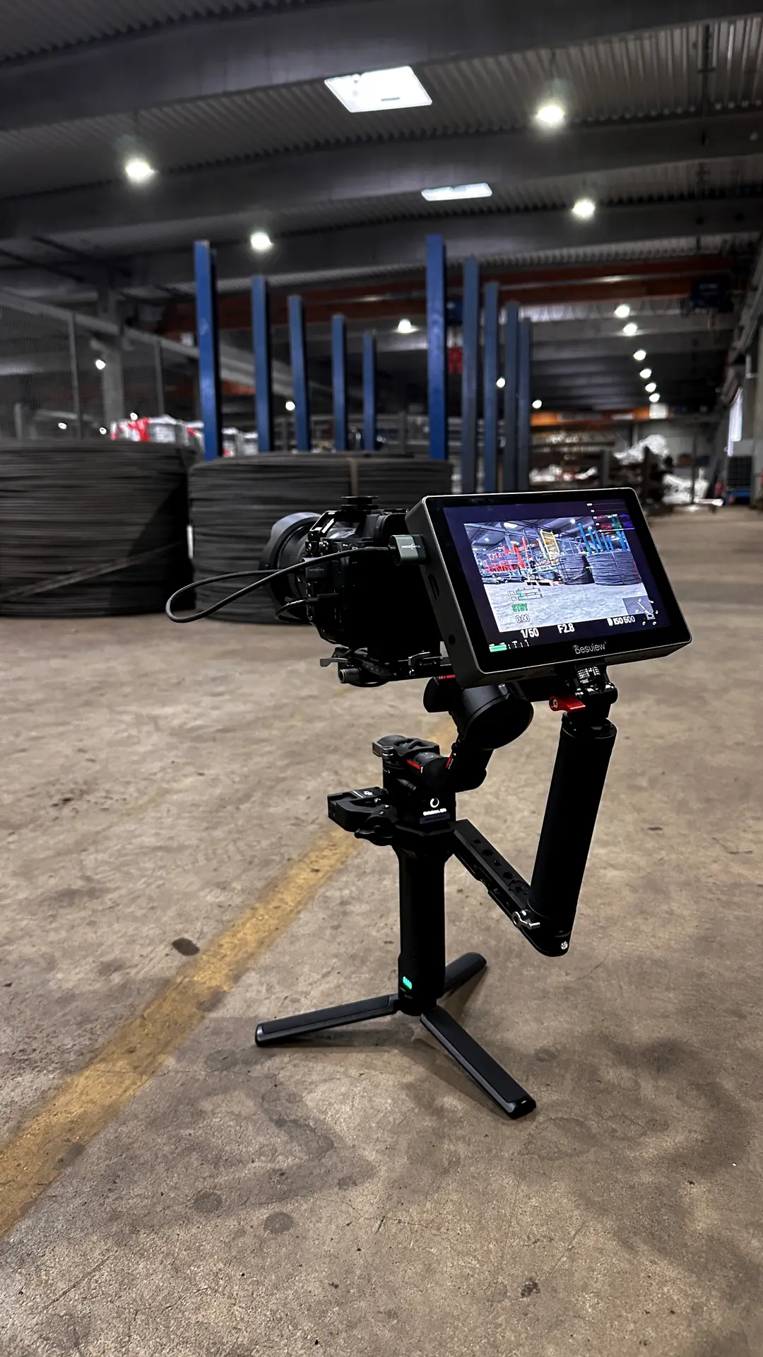 Camera on a gimbal with monitor inside a steel warehouse