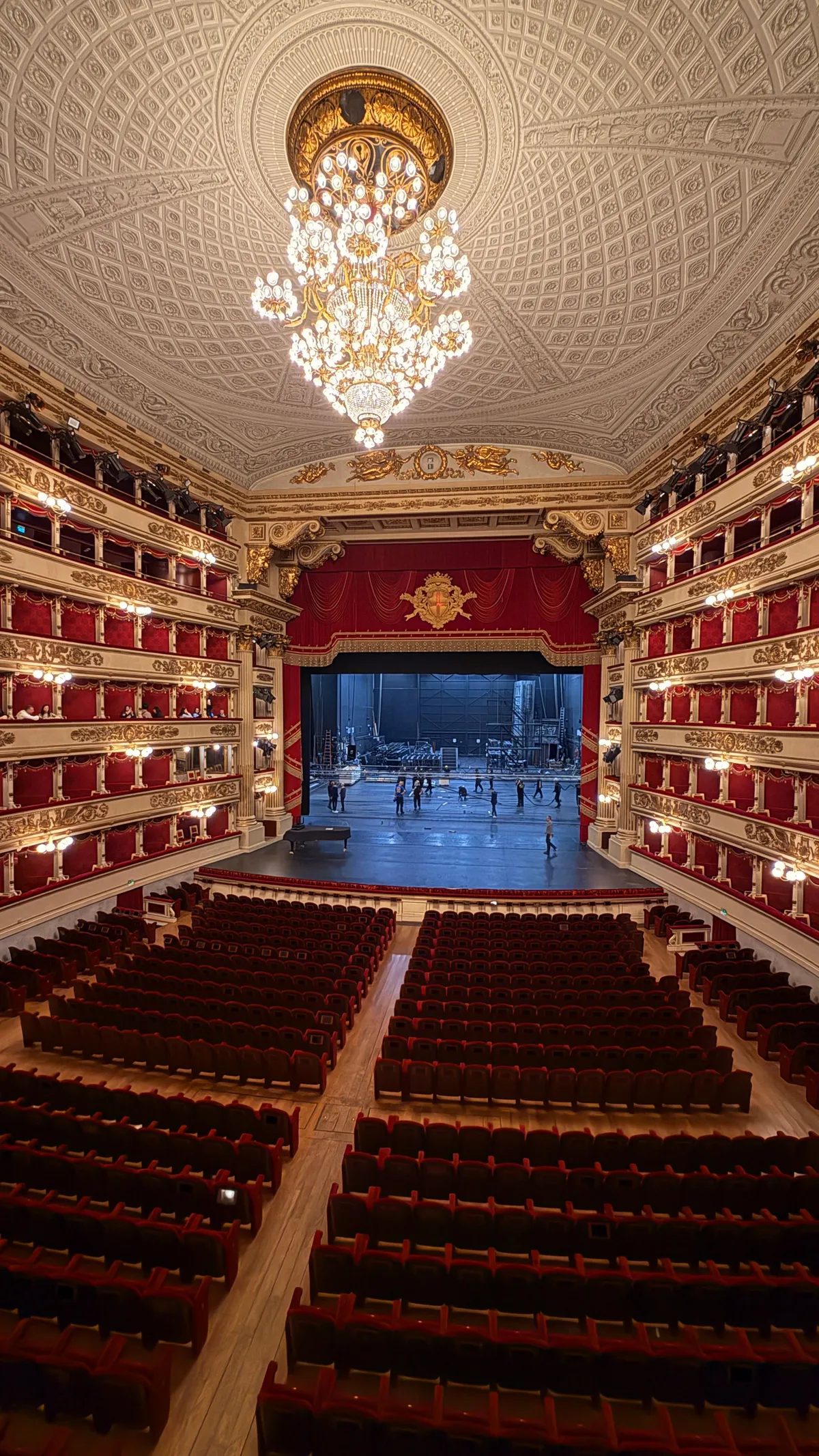 Auditorium of La Scala seen from the stalls: red velvet seats, gilded boxes and the great chandelier